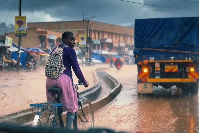 Ugandan online rally to support girl filmed riding bicycle to school in heavy downpour